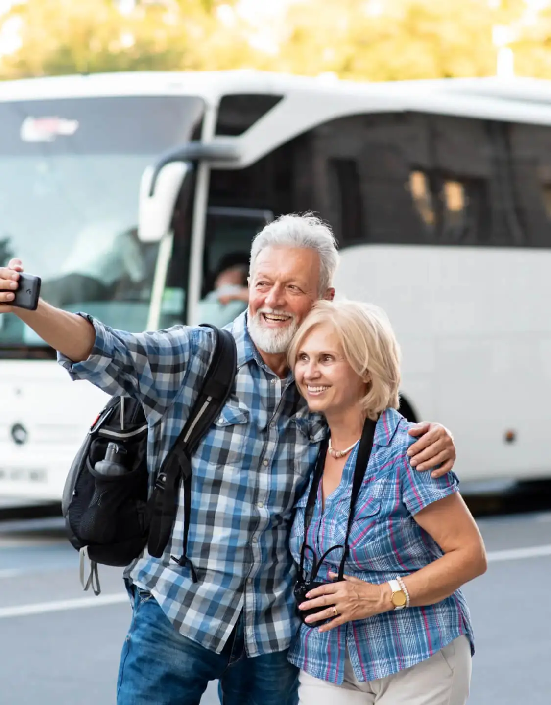 Happy couple taking a selfie standing front of bus Banner - for mobile